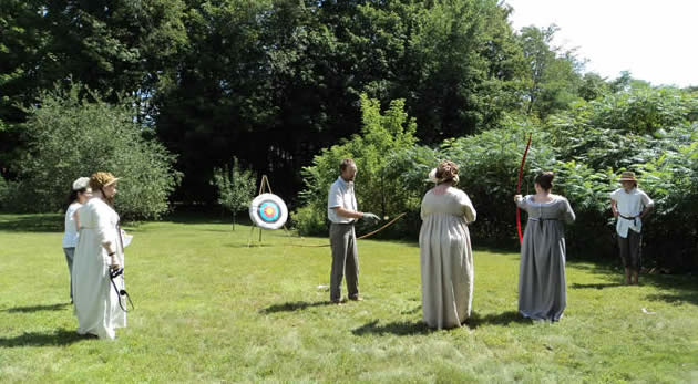Costumes participants try archery at the Jane Austen in character weekend