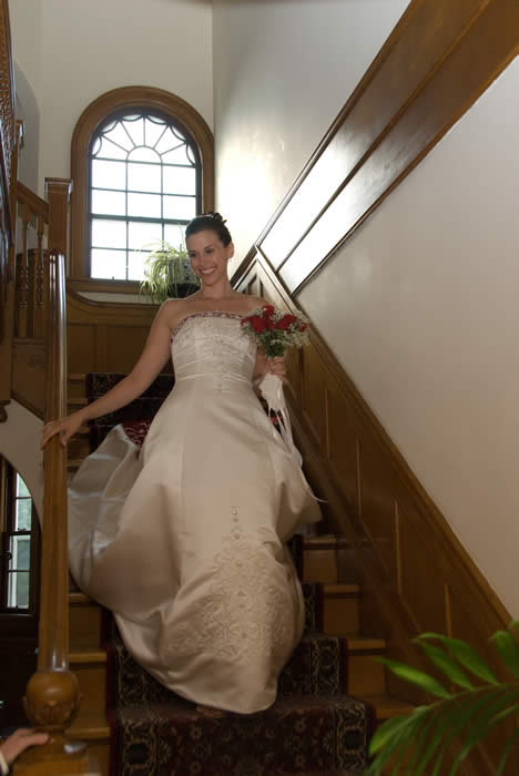bride on elegant staircase at Vernont inn, Vermont elopement package with video