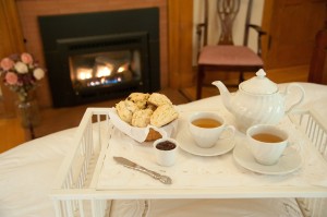 bedtray with tea and scones and fireplace in he background