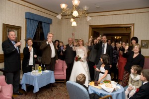 Wedding party and guests making a champagne toast