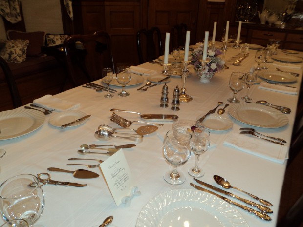 Place settings in different stsyles and display of silver serving pieces